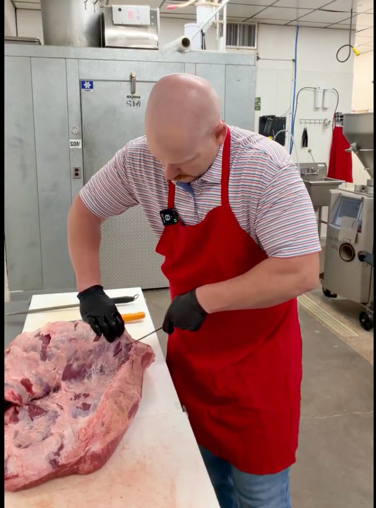 Strick's butcher breaking down a whole beef chuck roll